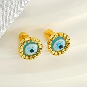 Minimalist stainless steel evil eye studs with gold finish and blue center on white texture