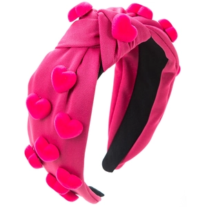 Detailed view of handmade rose red knotted headband with plush heart-shaped ornaments
