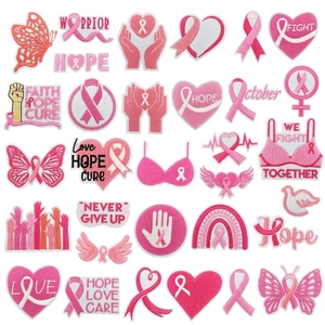Detailed macro view of 32 pink ribbon embroidery patches with hope and warrior motifs