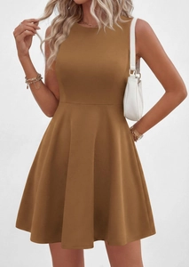 Detail of a brown sleeveless A-line dress with a crew neck and cinched waist on a model