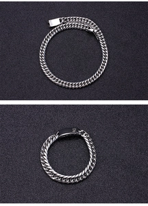 Macro shot of silver curb link stainless steel necklace with premium metallic luster