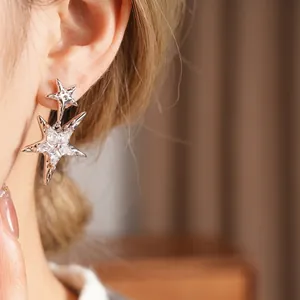 Star-shaped silver needle earrings with inlaid zircons and double star drop design