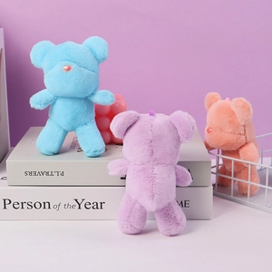 Three plush candy-colored bear keychains in blue, purple, and pink on a purple background