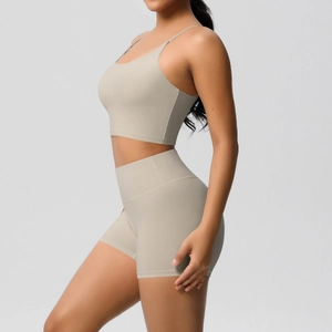 Detail view of seamless light beige yoga set showing supportive sports bra and high waist shorts