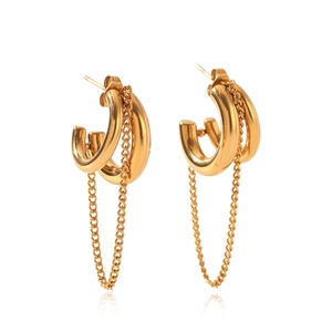 Close-up of chunky gold hoop earrings with long hanging metal fringe chains on white background