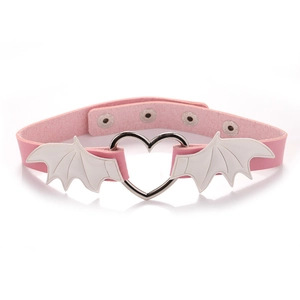 Detail of pink PU leather choker with white bat wings and heart-shaped metal buckle