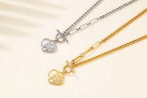 Detail of silver and gold heart necklaces with mixed Cuban and paperclip chains