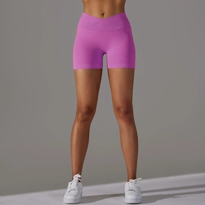 Dettaglio degli shorts da yoga magenta con vita alta incrociata e trama a maglia