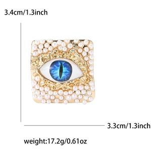 Detail of square gold evil eye brooch with blue inlay and pearls showing dimensions