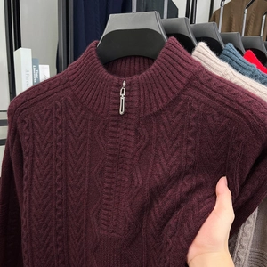 Detail of burgundy cable knit sweater showing thick texture and zipper collar stand