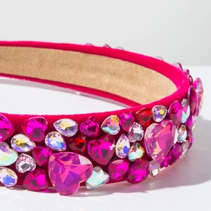 Macro detail of luxury wide headband with pink and red heart crystals on velvet fabric