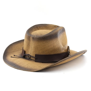 Détail d'un chapeau de cowboy en paille tressée avec bord usé et bande en cuir