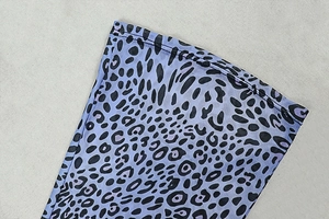 Close-up of purple leopard print sheer mesh fabric with reinforced stitching detail