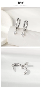 Detail of silver drop earrings with round cubic zirconia and hinged clicker closure