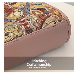 Detail shot of pink leather stitching and bear jacquard fabric on a crossbody bag