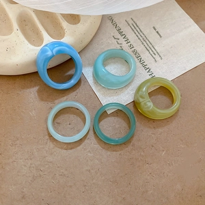 5-piece resin ring set in marble blue and mint green with smooth minimalist finish