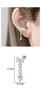 Detail of silver bow earrings with pink heart tassel and clear zircon stones