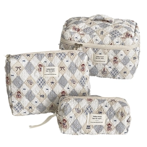 Three-piece quilted bear cosmetic bag set in beige and blue plaid with carry handle