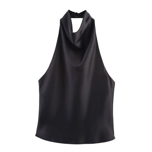 Close-up of black satin halter top featuring silky texture and elegant neck pleats