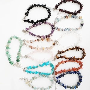 Detail view of colorful irregular crushed gemstone bracelets with metal lobster clasps