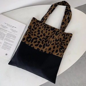 Detail of leopard print canvas tote bag featuring a high-contrast patchwork design