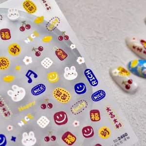 Detail of embossed nail art stickers featuring lucky symbols and cute cartoon elements