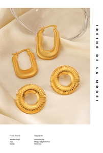 Detailed close-up of 18K gold-plated titanium earrings with vertical ridged texture