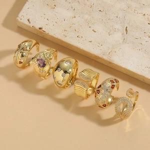 Luxury 14K gold plated zircon rings set displayed on a beige marble stand