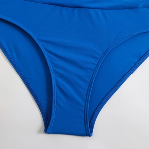 Detailed close-up of high-elasticity royal blue bikini bottoms with durable double stitching
