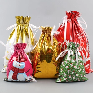 Detailed view of assorted Christmas drawstring gift bags in metallic festive colors