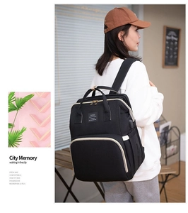 Detail view of stylish black diaper backpack with USB port and waterproof material