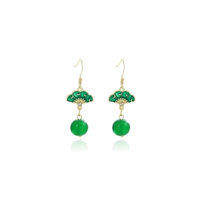 Detail of green fan-shaped earring with bamboo leaf motif and dangling bead