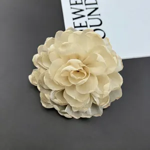Detail of multi-layered cream chiffon chrysanthemum fabric flower for dresses