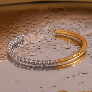 Close-up of a two-tone twisted rope bracelet with gold and silver stainless steel finish