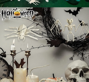 Detailed Halloween decor set featuring realistic skeleton spider, bat, and skull props