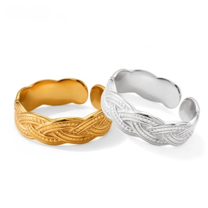 Close-up of gold and silver twisted cable stainless steel rings with adjustable open bands