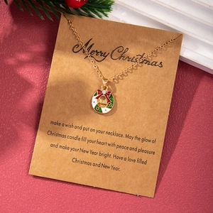 Detailed view of Christmas wreath pendant with red bow on a festive wish card