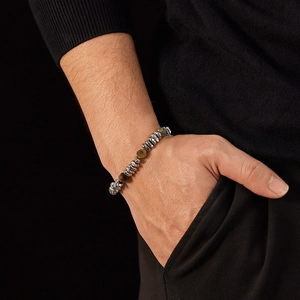 Close-up of stainless steel bracelet with natural yellow tiger eye beads on male wrist