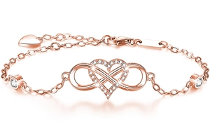 Detail view of rose gold infinity heart bracelet with cubic zirconia on white background