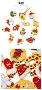 Detailed view of colorful Christmas enamel charms including gingerbread man and tree