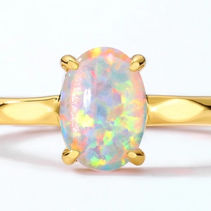Elegant 925 silver gold plated ring featuring a large oval synthetic opal with fire effect