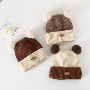 Winter knit baby hats with pom-poms for ear protection in brown and beige tones