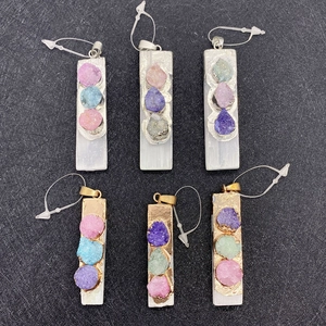 Detailed view of rectangular natural selenite pendants with colorful crystal inlay