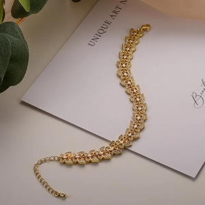 Elegant gold-plated butterfly bracelet with zircon crystals on a minimalist white card