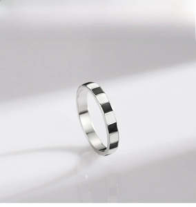 Macro detail of S925 sterling silver ring with classic black and white enamel checkerboard
