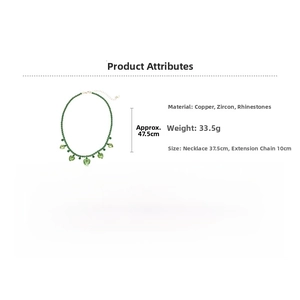 Detail of emerald green zircon heart charms on a beaded copper necklace with parameters