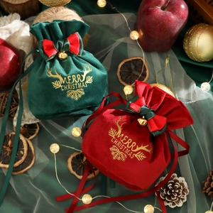Velvet Christmas drawstring gift bags with gold bells and Merry Christmas reindeer prints