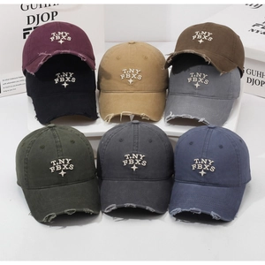 Close-up of vintage washed cotton baseball caps with distressed brims and star embroidery