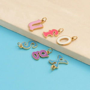 Colorful enamel A-Z letter pendants with gold plated borders on a stone base