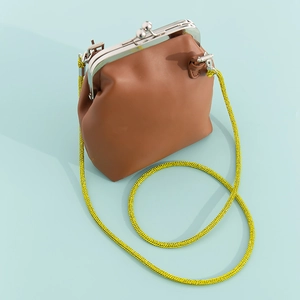 Mini brown leather crossbody bag with bright neon yellow chain strap and silver clasp